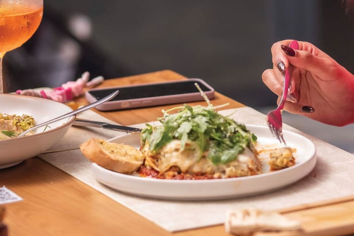 Beef lasagna with rocket and garlic bread